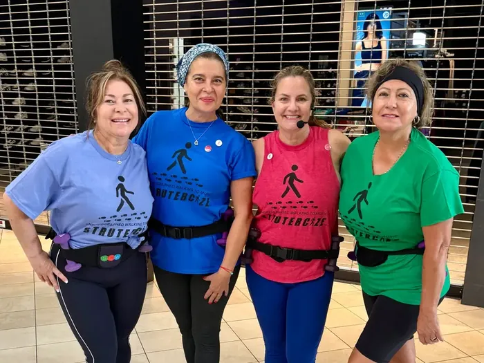 Four strutters in bright team tees and waist packs, ready to walk